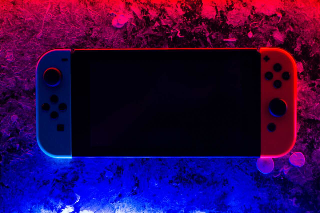 Game console with a red and blue background creating a high-contrast, eye-catching effect.